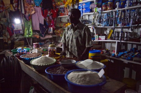 A shop keeper in rural area use solar lantern to light up the shop