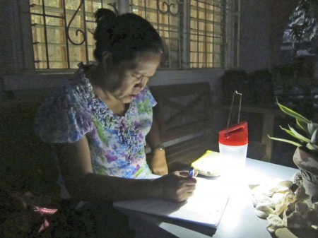 A woman using the affordable solar power lantern.